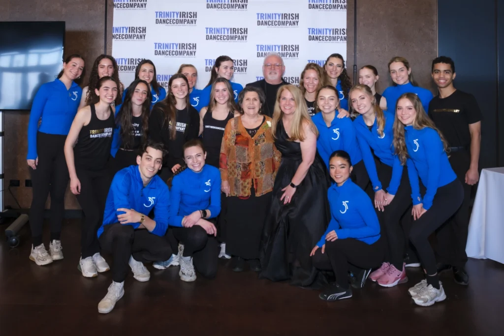 Gail Kalver and Shannon Hofman Bunting gather for a photo with the Trinity Irish Dance Company